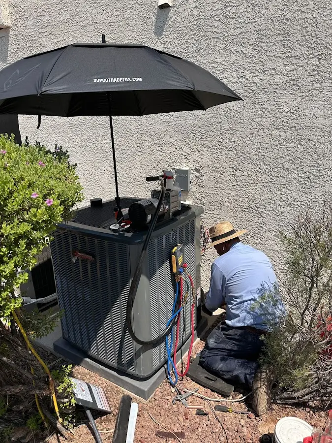 HVAC technician performing outdoor AC maintenance in Canyon